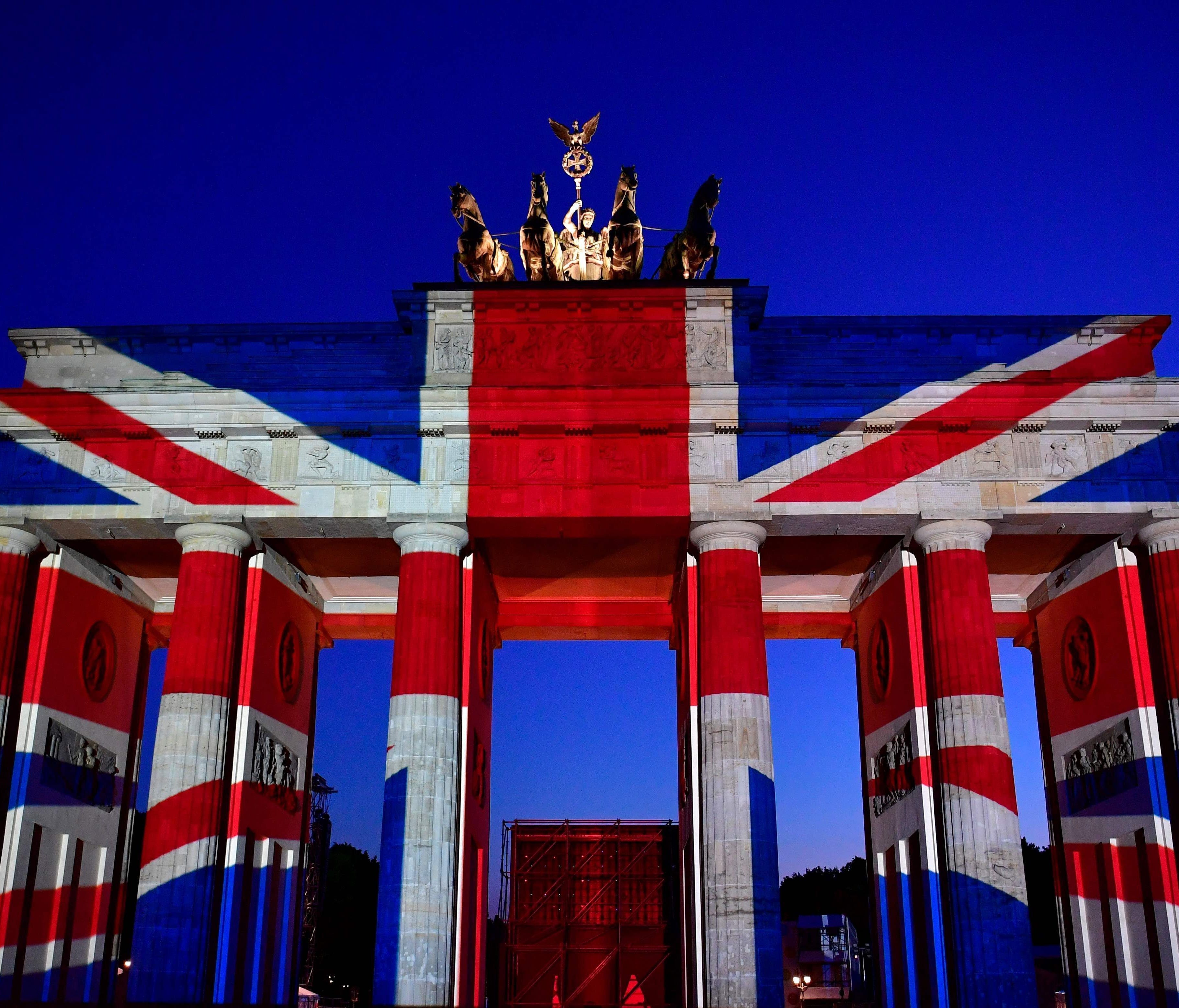 The colors of British flag are projected on Brandenburg Gate on Sunday in Berlin, as tribute to the victims of the Saturday terror attack in London.