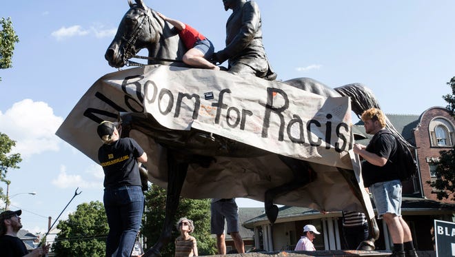 Members of the Louisville Showing Up for Racial Justice group scaled and defaced the Castleman statue in the Highlands on Saturday to voice outrage for its supposed offensiveness. 8/19/17