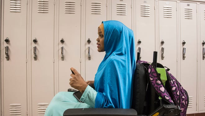 Fardowsa Sharif uses a wheelchair to navigate the long-hall design of Iroquois High School in her final days as a student. 5/24/18