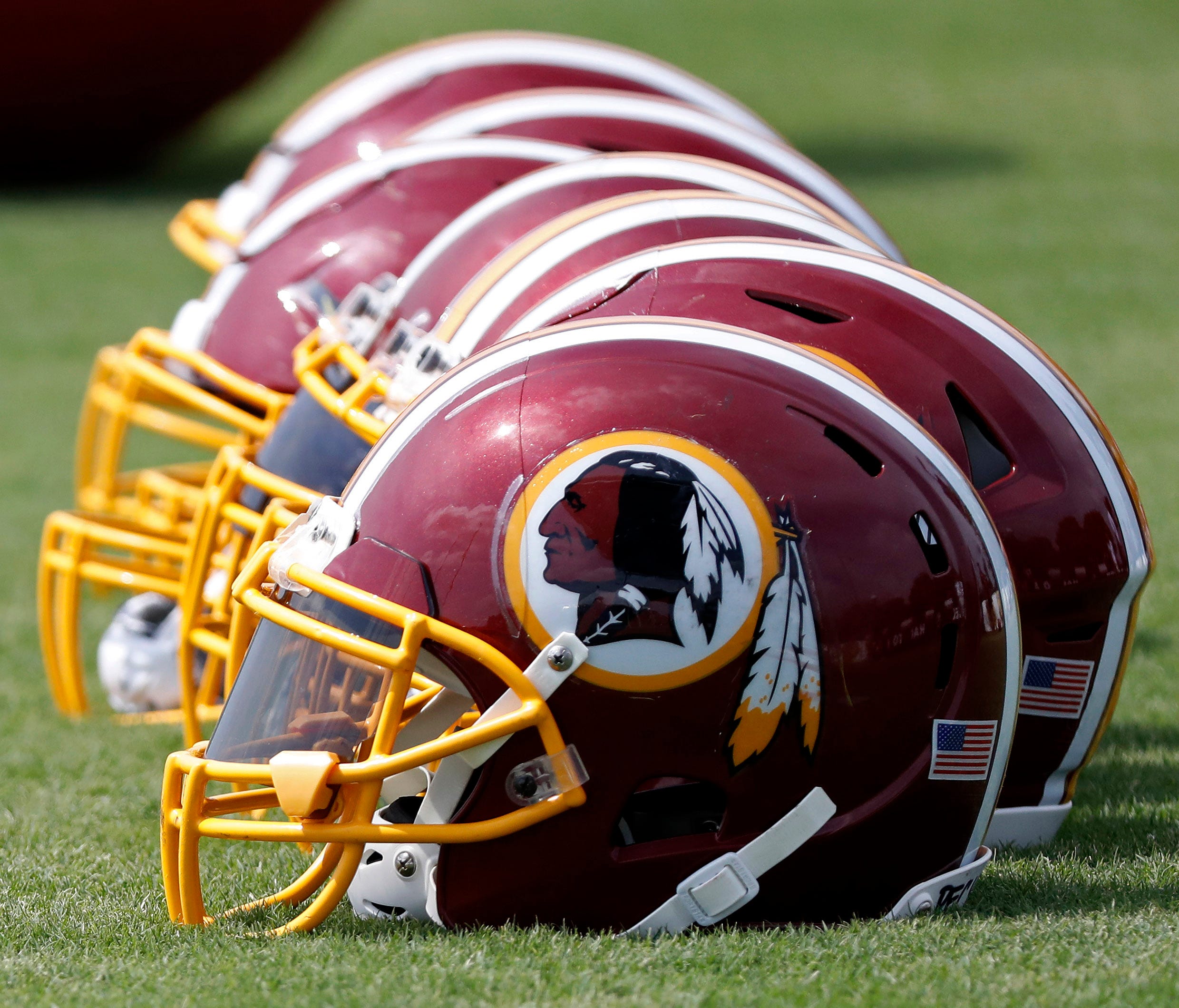 Washington Redskins players' helmets rest on the field during training camp.