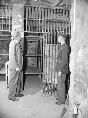 Officer Neul Weaver and Detective Richard Hughes inside the old county jail, Jan. 21, 1951.