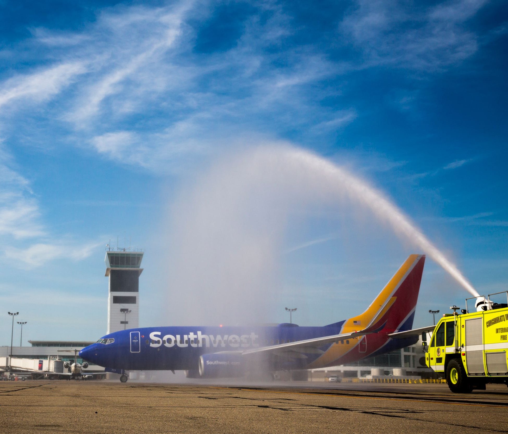 The first Southwest plane to take off from Cincinnati/Northern Kentucky International Airport receives a traditional water-cannon salute on Sunday, June 4, 2017.