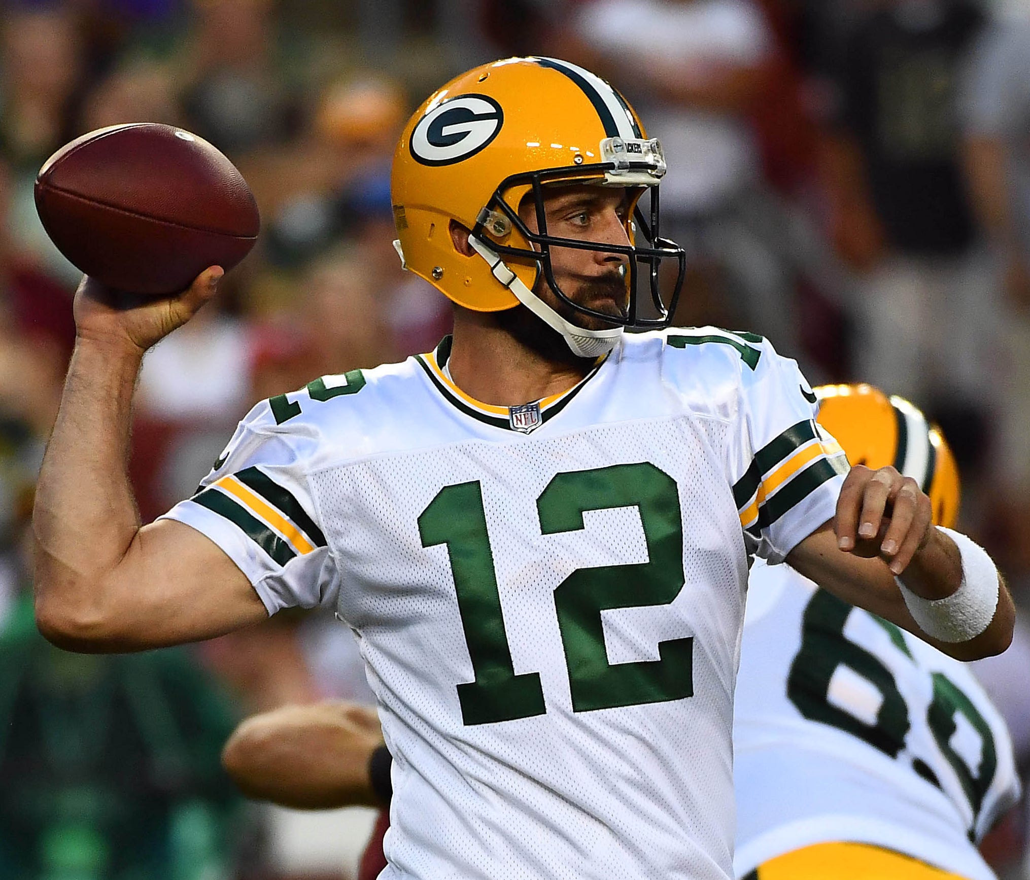 Green Bay Packers quarterback Aaron Rodgers drops back to pass against the Washington Redskins during the first half of a preseason game at FedEx Field.