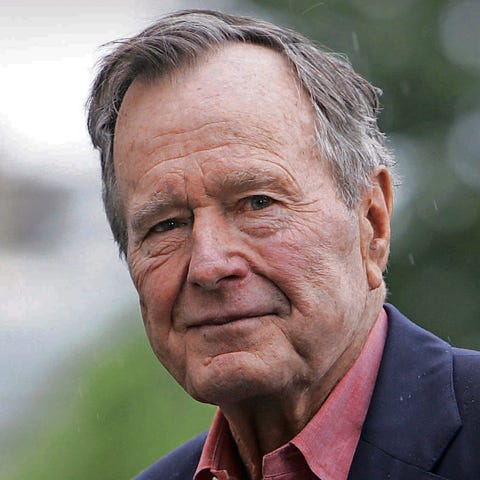 Former president George H.W. Bush, arrives on the...