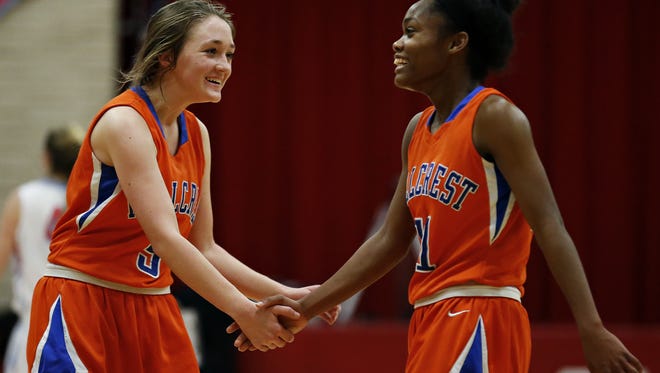 Hillcrest High School sophomore Sarah Hale (5) and senior Kaycee Gerald (11) celebrate after the end of the Hornets' game against Glendale High School.