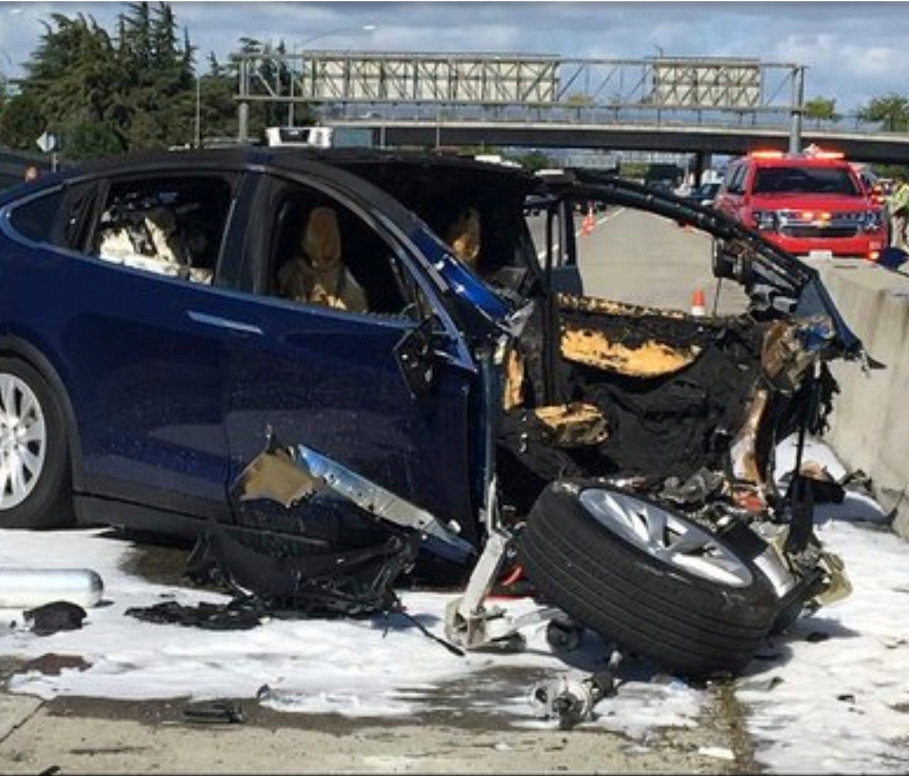 In this Friday March 23, 2018 photo provided by KTVU, emergency personnel work a the scene where a Tesla electric SUV crashed into a barrier on U.S. Highway 101 in Mountain View, Calif. The National Transportation Safety Board has sent two investigat