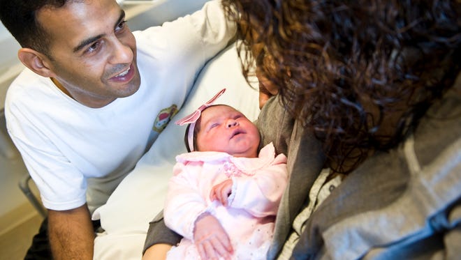 Bolivar  and Sandra Vilchez watch over their newborn daughter, Savannah, at Kaiser Permanente in Anaheim, Calif.