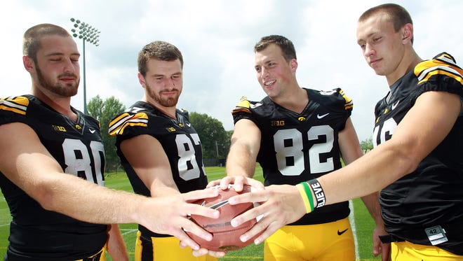 Iowa tight ends Henry Krieger Coble, from left, Jake Duzey, Ray Hamilton and George Kittle pose for a photo during Iowa football media day on Monday, Aug. 4, 2014.