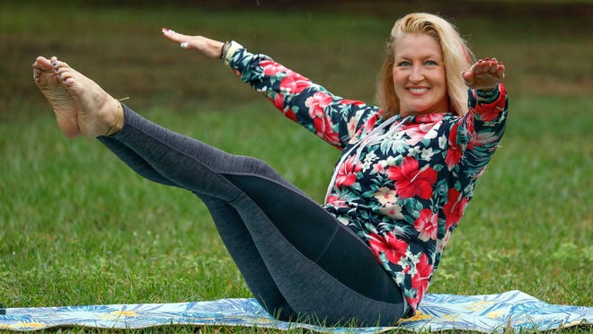 Marlo Alleva demonstrates a boat pose with extended pulsing arms.