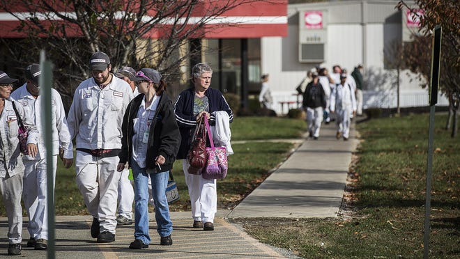 First-shift employees exit the Marujun factory in Winchester Wednesday, Nov. 11, 2015. The factory, which employs more than 750 workers, will be closed by next November.