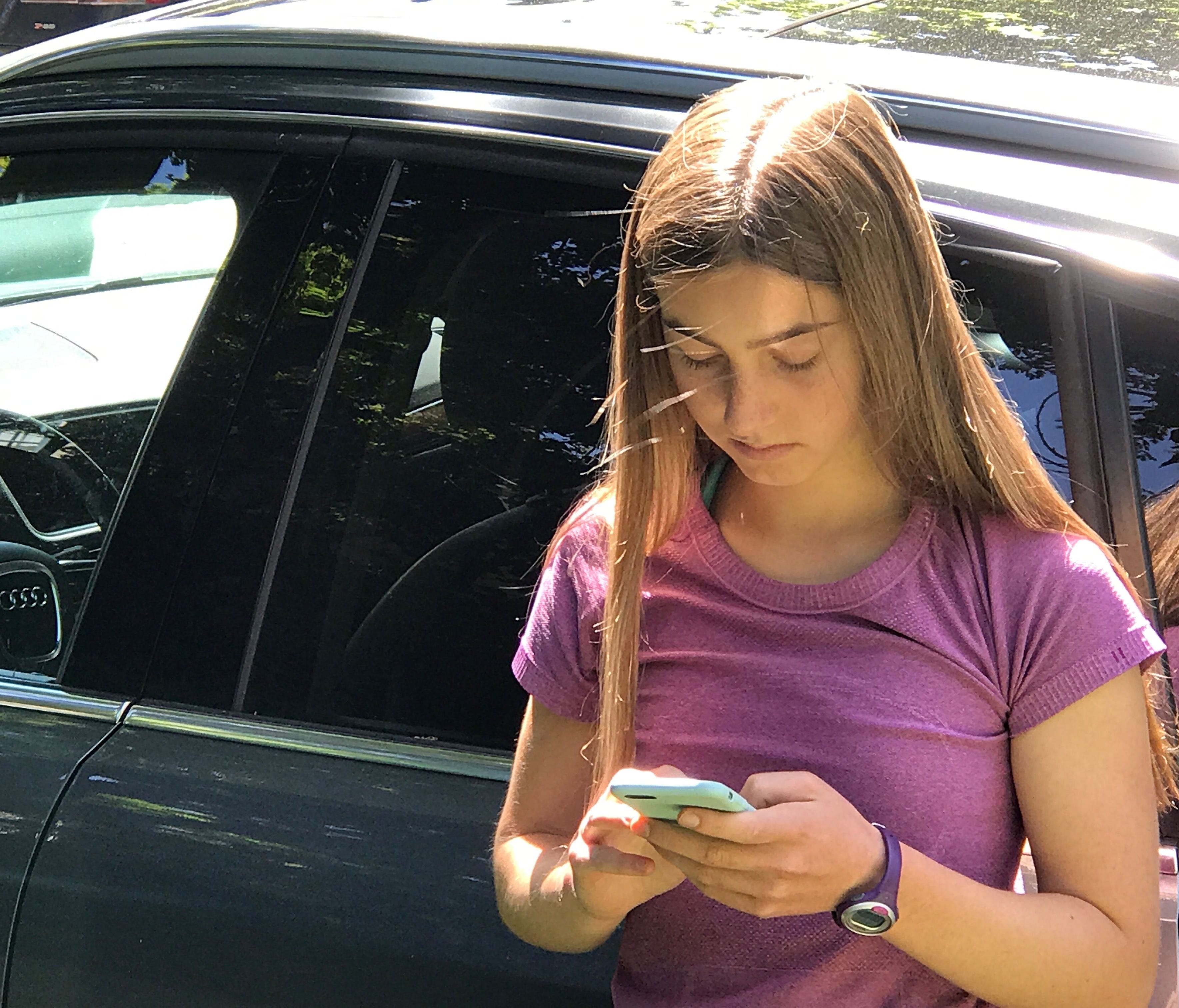16-year-old Jeneva Toolajian, daughter of columnist Jennifer Jolly, texts on her iPhone in Oakland. CA.
