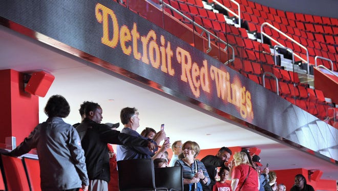 Fans take pictures of the arena from mezzanine section M19A.