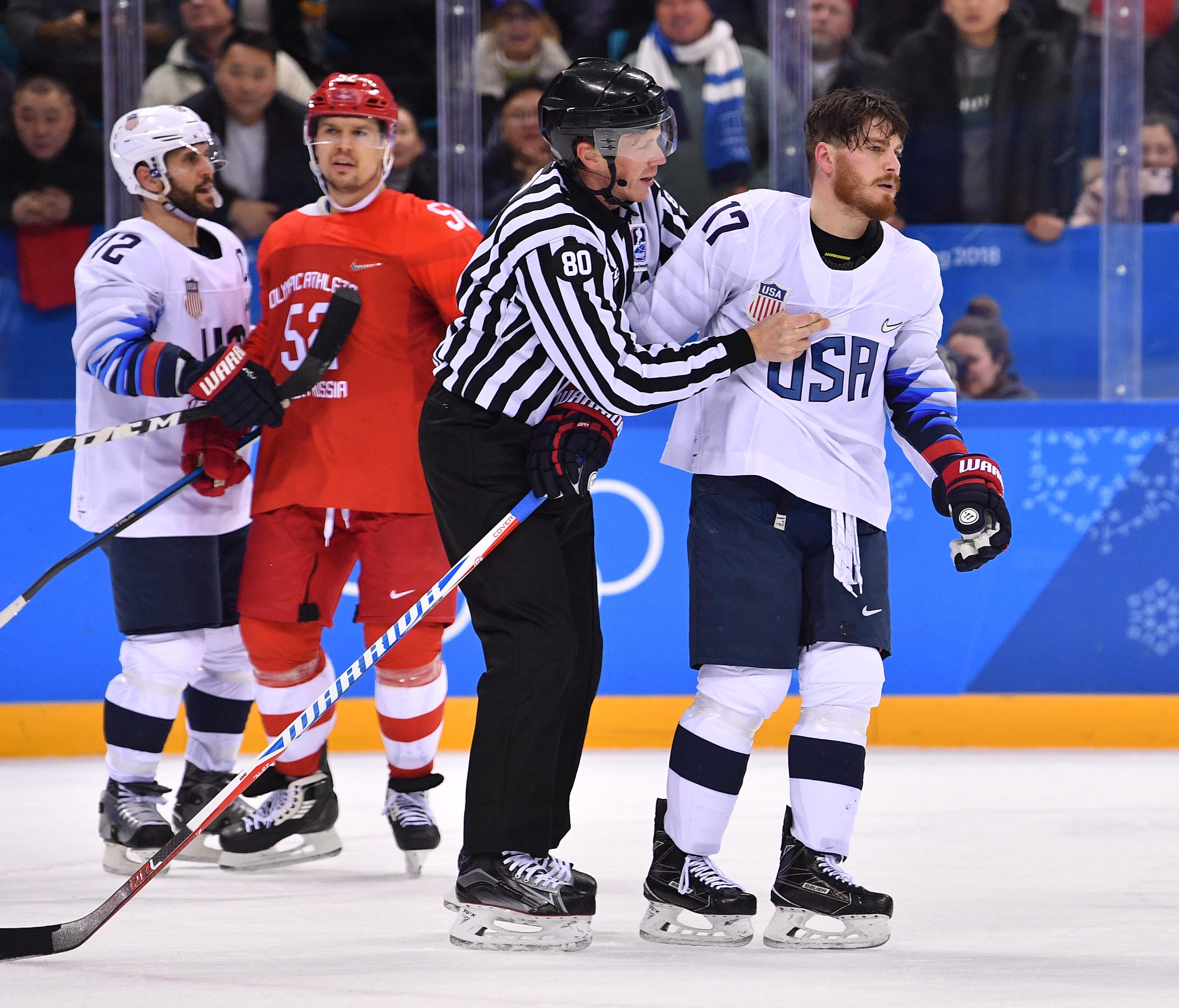 United States forward Chris Bourque (17) is pulled out of a fight with Russia players by an official in the second period during men's ice hockey Group B play in the Pyeongchang 2018 Olympic Winter Games.