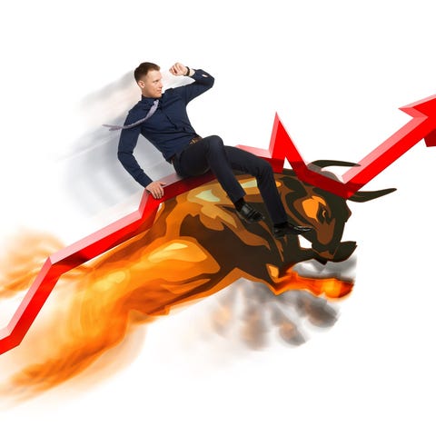 Man riding a bull up a rising red arrow