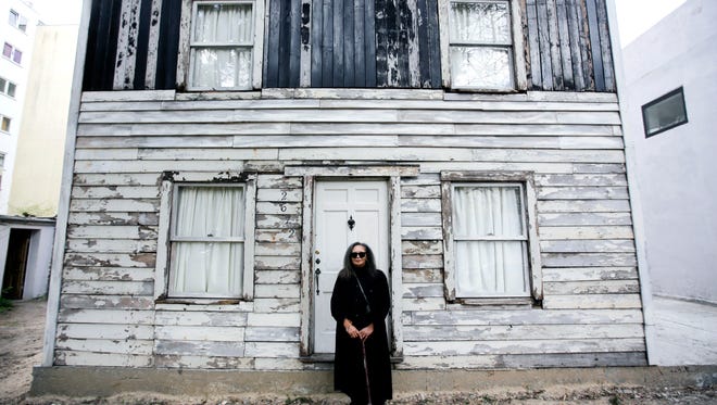 In this April 6, 2017 file photo, Rhea McCauley, a niece of the late civil rights activist Rosa Parks, poses in front of the rebuilt house of Rosa Parks in Berlin. Brown University announced Thursday, March 8, 2018, it has canceled plans to display the house where Rosa Parks lived after sparking the Montgomery bus boycott.