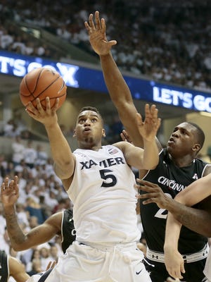 Xavier Musketeers guard Trevon Bluiett (5) shoots a layup in the first half of the 83rd annual Crosstown Shootout NCAA basketball game between the Xavier Musketeers and the Cincinnati Bearcats at the Cintas Center in Cincinnati Saturday, Dec. 12, 2015. At the half, Xavier led 42-26.