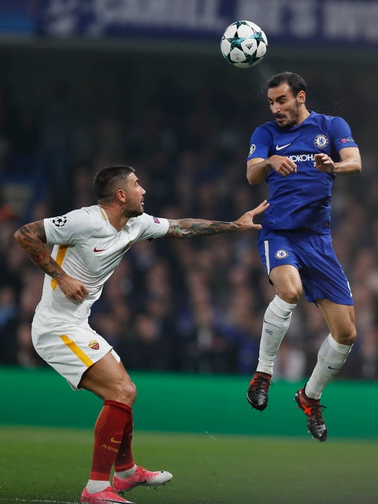Chelsea's Davide Zappacosta, heads the ball as Roma's Aleksandar Kolarov stands during the Champions League group C soccer match between Chelsea and Roma at Stamford Bridge stadium in London, Wednesday, Oct. 18, 2017. (AP Photo/Kirsty Wigglesworth)