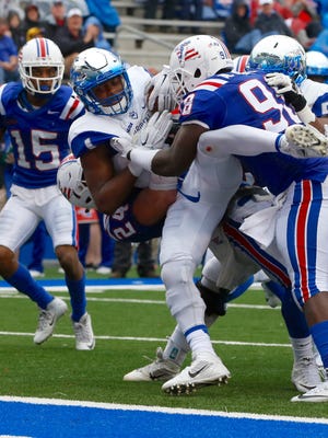 MTSU's Shane Tucker is stacked up at the line by Louisiana Tech with the Blue Raiders pinned near their goal line.