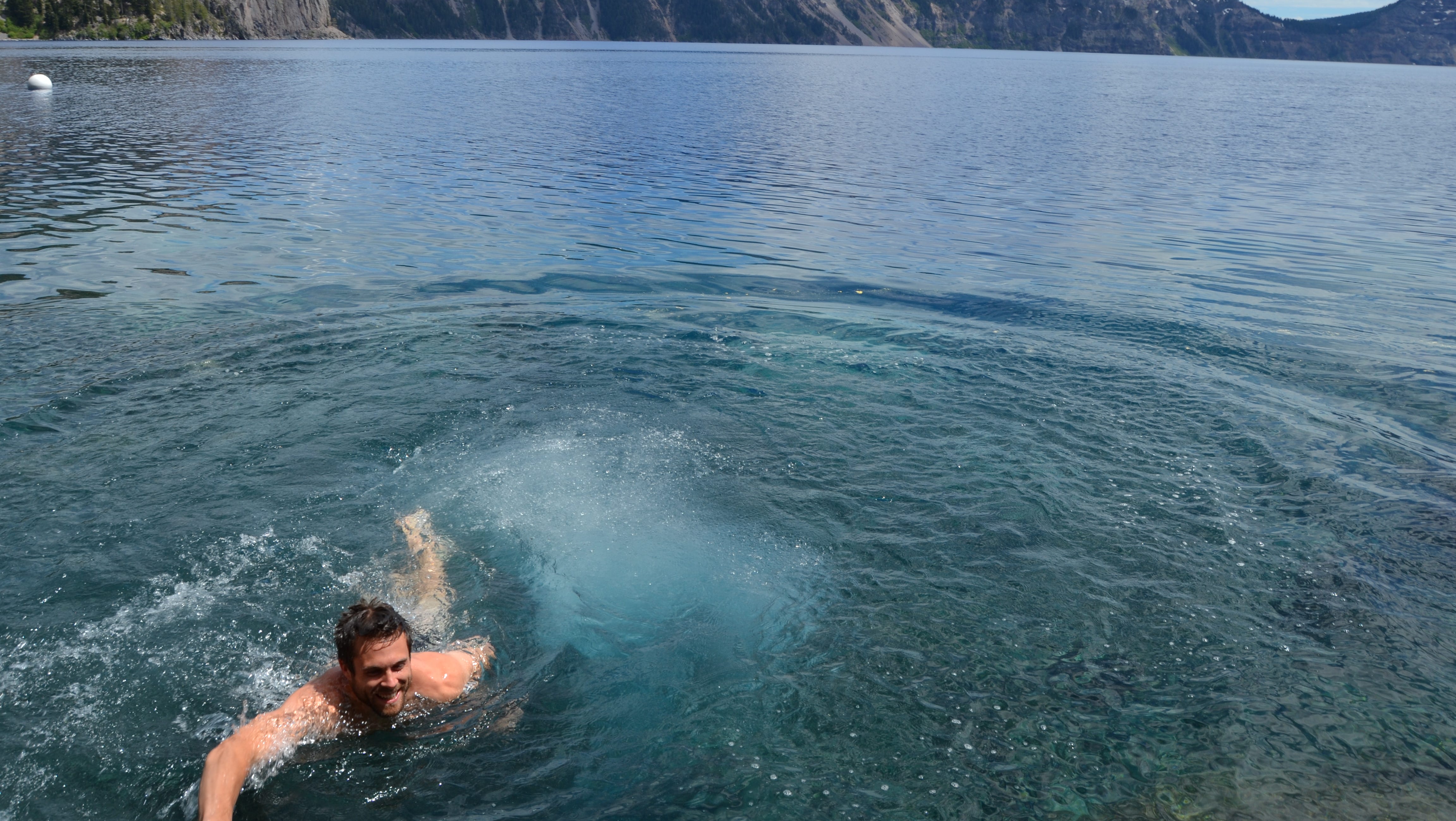 Tyler Dodds swims back to shore after jumping into the icy cold waters of Crater Lake.