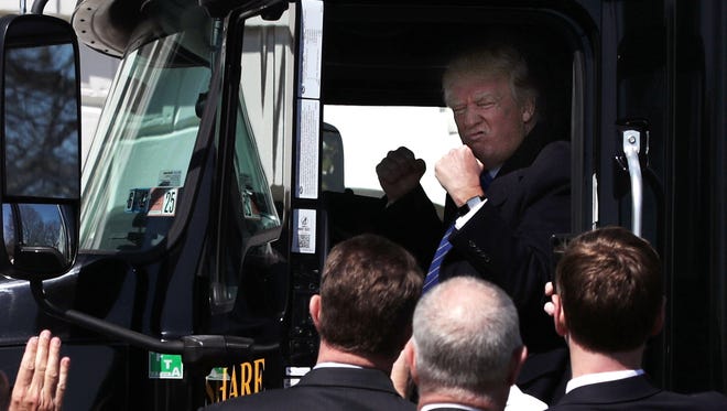 President Trump sits in the cab of a truck as he welcomes members of American Trucking Associations to the White House March 23, 2017.