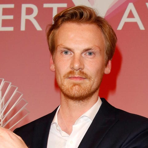 German journalist Claas Relotius holds his award...