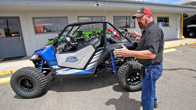 Darryl Dunlap, owner and operator of Dunlap Performance and Motorsports, talks on April 28 at his shop in Farmington about how to make an off-highway vehicle side by side street legal.