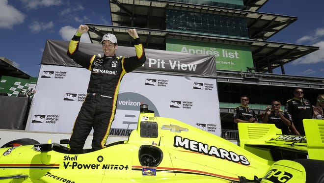 IndyCar driver Simon Pagenaud celebrates winning the pole position for the Angie's List Grand Prix of Indianapolis Friday, May 13, 2016, afternoon at the Indianapolis Motor Speedway.
