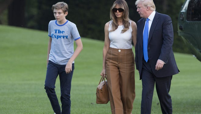 First lady Melania Trump, son Barron and President Trump arrive at the White House June 11, 2017.