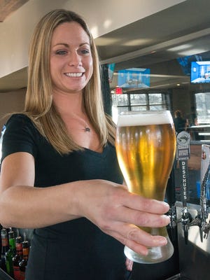 Bartender Amanda Jendrusina poured a Labatt beer  from one of 16 taps.