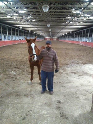 Glenn Martin and Cody, his Arabian horse, at Ravenwood Stables in Carleton, Mich.