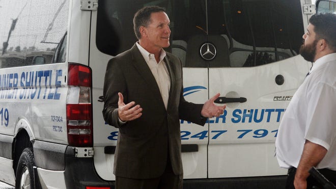 Roadrunner Shuttle and Limousine Service CEO Brad "Brick" Conners, left, talks with Chief Operating Officer Charles Sandlin. Conners is leading the addition of new contracts and an expansion of the business.
