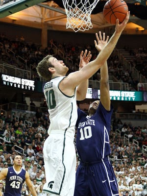 Michigan State forward Matt Costello lays the ball up over Penn State forward Brandon Taylor during Wednesday's game at Breslin Center. MSU won 66-60.