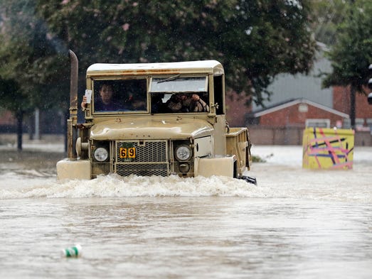 A truck pushes through floodwaters from Tropical Storm