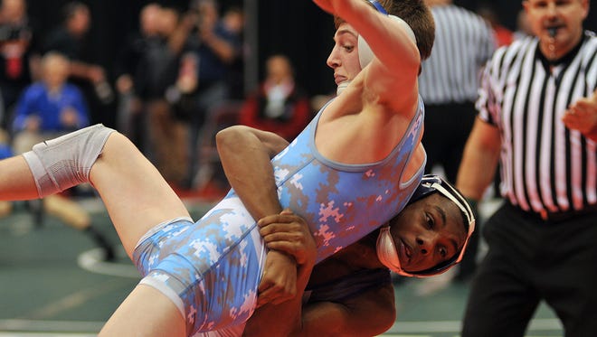 Lamonte Chapman, bottom, of Fremont Ross competes on the first day of the state tournament in March.