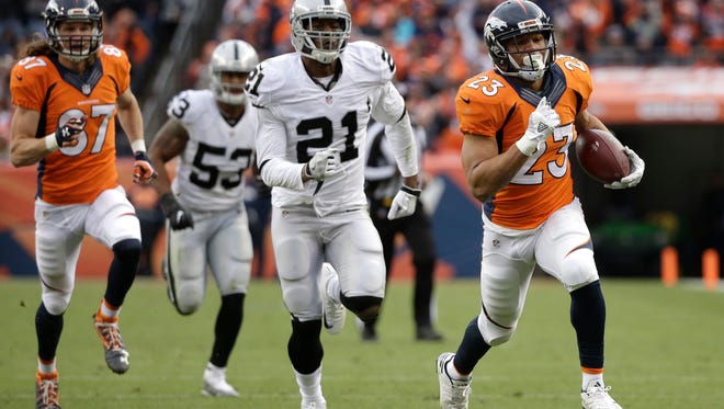 Denver Broncos running back Devontae Booker, right, runs for his second touchdown of the first half against the Oakland Raiders during an NFL football game, Sunday, Jan. 1, 2017, in Denver. (AP Photo/Jack Dempsey)