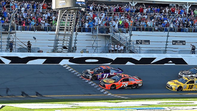 Feb 21, 2016; Daytona Beach, FL: NASCAR Sprint Cup Series driver Denny Hamlin (11) beats Martin Truex Jr. (78) to win the Daytona 500 at Daytona International Speedway.