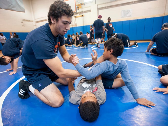 Coach Noah Turner works with nine-year-old Diomal Felix,