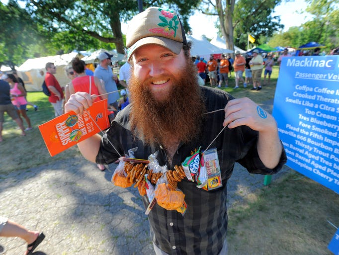Joe Gassel, of Ypsilanti, holds up the snack necklace