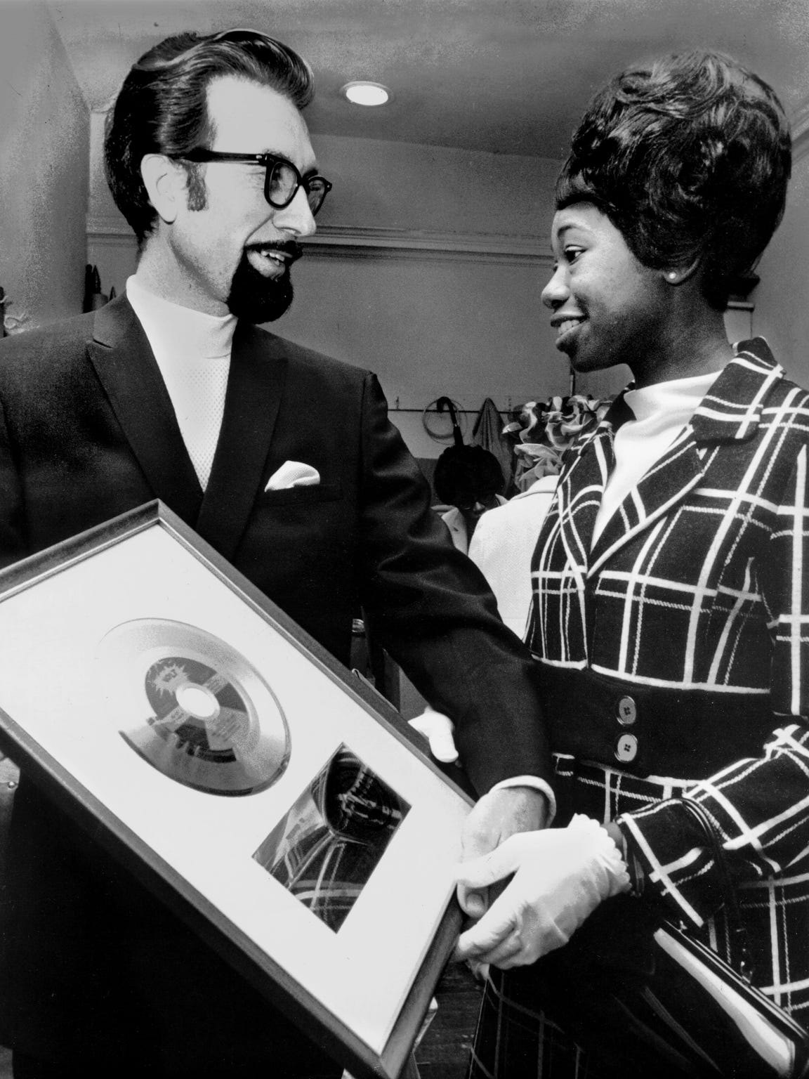 Stax Records president Jim Stewart presents Zelma Redding, wife of Otis Redding, with a gold record for "Dock Of The Bay", which was recorded at Stax four days before the late "King of the Memphis Sound" died in a Wisconsin plane crash.