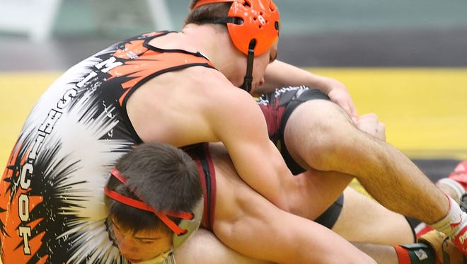 Fond du Lac's Josh Adams and Mishicot's Weston Cracraft meet in the 145 pound class championship match Tuesday at the Oshkosh Lourdes on the Water Classic wrestling tournament.