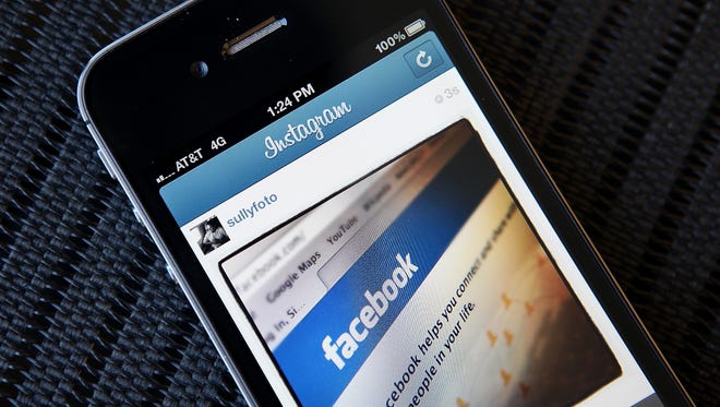 An Instagram photo of the Facebook website app is seen on an Apple iPhone.
