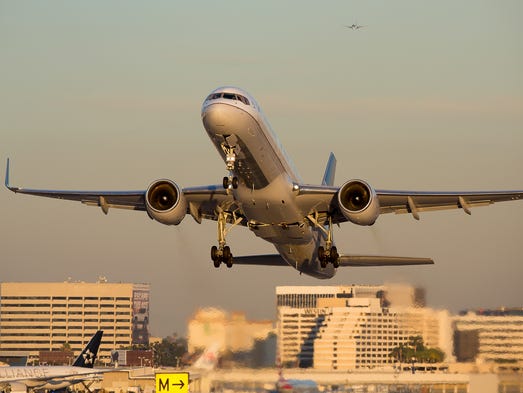 A United Airlines Boeing 757-200 takes off from sunny