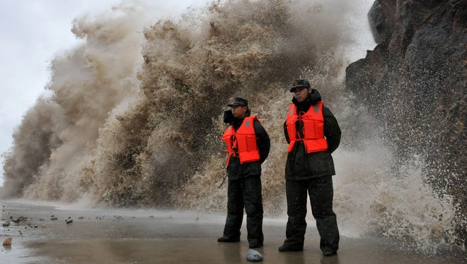 A huge wave hits the dike as Typhoon Fitow moves to make its landfall in Wenling, east China's Zhejiang province on Oct. 6, 2013.