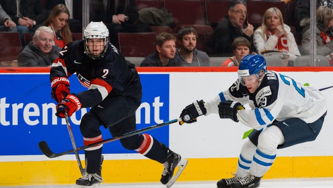 DECEMBER 26: Noah Hanifin of Team United States passes the puck near Otto Rauhala #29 of Team Finland during the 2015 IIHF World Junior Hockey Championship game at the Bell Centre on December 26, 2014 in Montreal, Quebec, Canada.