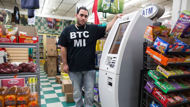 Andrew Konja from Novi stands next to one of his Bitcoin ATMs on Friday, Nov. 6, 2015 at Timmy's Market in Detroit. Konja currently owns six Bitcoin ATMs and averages from 100-150 transactions per day, spanning all of the machines.