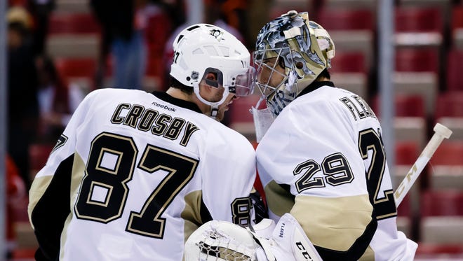 Pittsburgh Penguins goalie Marc-Andre Fleury (29) and center Sidney Crosby (87) celebrate after the game.