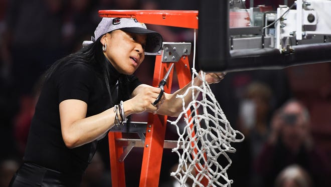 South Carolina head coach Dawn Staley cuts down the net following the SEC Championship at Bon Secours Wellness Arena on Sunday, March 5, 2017.