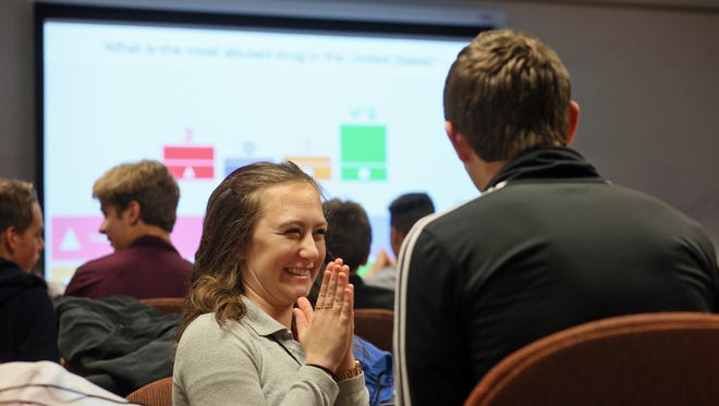 Shelby Abbott, a junior at Johnstown High School, reacts as her team advances in a game of Kahoot! Thursday morning during the Licking County Leaders Summit at OSU-N and COTC. Students from around Licking County gathered to learn about and discuss behavioral health issues including drug abuse, violence, suicide and bullying. Students in this session divided into small teams and used their cell phones to take an interactive online quiz focusing on drugs and alcohol.  