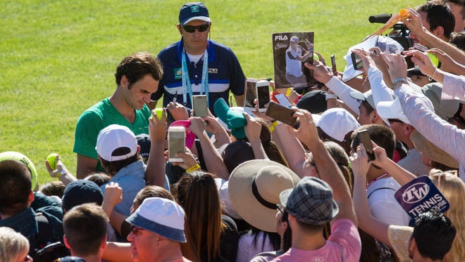 Roger Federer signs autographs for fans at the BNP Paribas Open in Indian Wells on March 8, 2017.