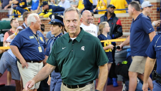 Michigan State coach Mark Dantonio smiles as he enters the field prior to the game against Michigan on Oct. 7.